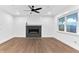 Modern living room featuring a stylish fireplace with electric insert, hardwood flooring, and ample natural light at 656 Avondale Park Cir, Decatur, GA 30032