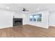 Modern living room featuring a stylish fireplace with electric insert, hardwood flooring, and ample natural light at 656 Avondale Park Cir, Decatur, GA 30032