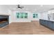 Open concept living room with a modern fireplace, luxury vinyl plank flooring, and recessed lighting at 656 Avondale Park Cir, Decatur, GA 30032