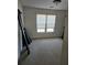 Bright bedroom with neutral carpet, window and blinds, and interesting exercise equipment at 275 Rose Ivy Ct, Lawrenceville, GA 30043