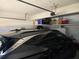 Organized garage space with overhead storage, car, and automatic door opener at 275 Rose Ivy Ct, Lawrenceville, GA 30043
