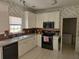 Traditional kitchen with white cabinets, tile countertops, and stainless steel appliances at 275 Rose Ivy Ct, Lawrenceville, GA 30043