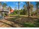 Large backyard surrounded by trees, with a glimpse of other houses in the background at 3274 Adelade Ct, Lithonia, GA 30038