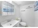 Small white bathroom with a modern vanity and a matching white toilet for space saving at 3274 Adelade Ct, Lithonia, GA 30038
