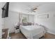 Comfortable bedroom featuring a queen-sized bed, ceiling fan, and natural light at 3274 Adelade Ct, Lithonia, GA 30038