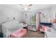 Bright Bedroom with daybed, crib, plush seating and natural light from a large window at 3274 Adelade Ct, Lithonia, GA 30038