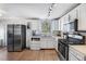 Bright kitchen features stainless steel appliances, white cabinets, and sleek countertops at 3274 Adelade Ct, Lithonia, GA 30038