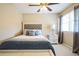 Bedroom featuring a queen-size bed, a gray headboard, and a window at 2914 Lenox Ne Rd # 12, Atlanta, GA 30324