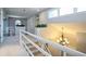 Hallway with staircase, chandelier, white railing, neutral carpet, and arched windows with indoor plants at 2914 Lenox Ne Rd # 12, Atlanta, GA 30324