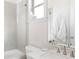 Bright bathroom featuring white tile, granite countertop, and modern fixtures at 12640 Hearthstone Way, Alpharetta, GA 30009