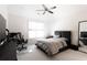 Modern bedroom with a black platform bed, sleek furniture, and natural light at 12640 Hearthstone Way, Alpharetta, GA 30009