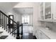 Hallway with white marble countertops, white cabinets, and open view to the living space at 12640 Hearthstone Way, Alpharetta, GA 30009