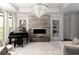 Elegant living room featuring tray ceilings, a fireplace, a piano, and large windows at 12640 Hearthstone Way, Alpharetta, GA 30009