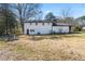 Spacious backyard view, showcasing the home's exterior with a large grass area at 6650 Baldwin Ct, Riverdale, GA 30274