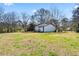 Wide view of home's back exterior with a large backyard area at 6650 Baldwin Ct, Riverdale, GA 30274