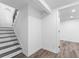 View of Basement stairs with neutral walls and modern flooring, leading to an adjacent room at 6650 Baldwin Ct, Riverdale, GA 30274