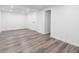 Spacious finished basement with ample lighting and light gray wood-look laminate flooring at 6650 Baldwin Ct, Riverdale, GA 30274