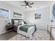 Bedroom with plush rug, ceiling fan, ample natural light, and modern decor at 6650 Baldwin Ct, Riverdale, GA 30274