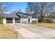 Charming home showcasing a two-car garage, a well-maintained lawn, and a classic design at 6650 Baldwin Ct, Riverdale, GA 30274