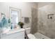 Modern bathroom with a glass-enclosed shower, gray tile, and a sleek vanity at 3836 Alice Ln, Suwanee, GA 30024