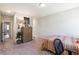 Cozy bedroom with carpet, neutral walls, and a dresser, adjacent to the entry hall at 3836 Alice Ln, Suwanee, GA 30024