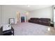 Large bonus room with plush carpet, neutral walls, and a comfortable reclining sofa at 3836 Alice Ln, Suwanee, GA 30024