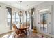 Cozy dining area with lots of windows offering natural light and a view to the home's beautiful outdoor space at 3836 Alice Ln, Suwanee, GA 30024