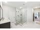 Gorgeous main bathroom with marble floors, a glass shower, large vanity, and neutral paint colors at 3836 Alice Ln, Suwanee, GA 30024