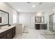 Clean and spacious main bathroom with marble floors, double vanity, glass shower, and a separate soaking tub at 3836 Alice Ln, Suwanee, GA 30024