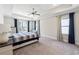 Tranquil main bedroom features a tray ceiling, carpeted floors, and an abundance of natural light from two windows at 3836 Alice Ln, Suwanee, GA 30024