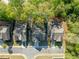 Aerial view of the property shows a well-maintained home nestled among mature trees at 551 Rokeby Dr, Woodstock, GA 30188