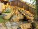 Backyard with a custom rock waterfall and landscaping at 551 Rokeby Dr, Woodstock, GA 30188