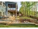 Beautiful backyard featuring a patio, fire pit, putting green, lake views, and a screened-in porch at 551 Rokeby Dr, Woodstock, GA 30188
