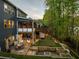 Stunning backyard featuring a patio, fire pit, putting green, multiple seating areas, and lush greenery at 551 Rokeby Dr, Woodstock, GA 30188