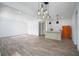 Large, open basement bar area with pendant lighting, modern appliances, and wood-look flooring at 551 Rokeby Dr, Woodstock, GA 30188