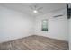 Clean, well-lit bedroom featuring a hardwood floor, ceiling fan, and mini split unit at 551 Rokeby Dr, Woodstock, GA 30188