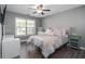 Cozy bedroom with hardwood floors, ceiling fan and view of surrounding landscape at 551 Rokeby Dr, Woodstock, GA 30188