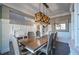 Charming dining room with wainscoting, modern light fixture, and seating for six at 551 Rokeby Dr, Woodstock, GA 30188