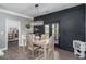 Stylish dining area with a modern light fixture and a dark accent wall at 551 Rokeby Dr, Woodstock, GA 30188