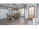 Bright dining room with decorative lighting fixture, hardwood floors, window views and access to the foyer at 551 Rokeby Dr, Woodstock, GA 30188