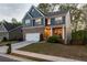 Charming two-story home with a brick and siding facade, well-manicured lawn, and attached two-car garage at 551 Rokeby Dr, Woodstock, GA 30188