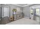 Inviting hallway with neutral tones and a decorative rug leads to the living area at 551 Rokeby Dr, Woodstock, GA 30188