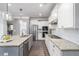 Modern kitchen featuring granite countertops, stainless steel appliances, and ample cabinet space at 551 Rokeby Dr, Woodstock, GA 30188
