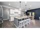 Modern kitchen features a large island with bar seating and stainless steel appliances for the home cook at 551 Rokeby Dr, Woodstock, GA 30188