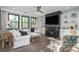 Cozy living room with a fireplace, built-in shelving, hardwood floors, and plenty of natural light at 551 Rokeby Dr, Woodstock, GA 30188