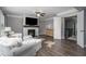 Bright living room with fireplace, TV, ceiling fan and hardwood floors at 551 Rokeby Dr, Woodstock, GA 30188