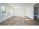 Bright living room with luxury vinyl plank flooring and three bright windows at 551 Rokeby Dr, Woodstock, GA 30188