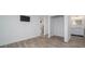 Living room featuring hardwood floors, neutral paint colors, and a hallway leading to the bathroom at 551 Rokeby Dr, Woodstock, GA 30188