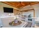 This outdoor kitchen features a built-in grill, wooden ceiling, and ample counter space perfect for entertaining at 551 Rokeby Dr, Woodstock, GA 30188