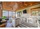 Enclosed porch with outdoor kitchen and ceiling fans at 551 Rokeby Dr, Woodstock, GA 30188